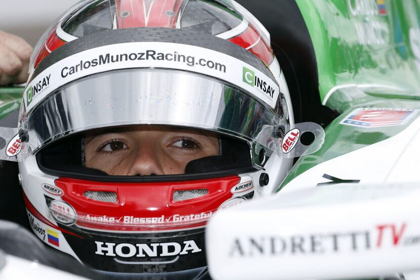May 12, 2014; Indianapolis, IN, USA; IndyCar Series driver Carlos Munoz sits in his car...