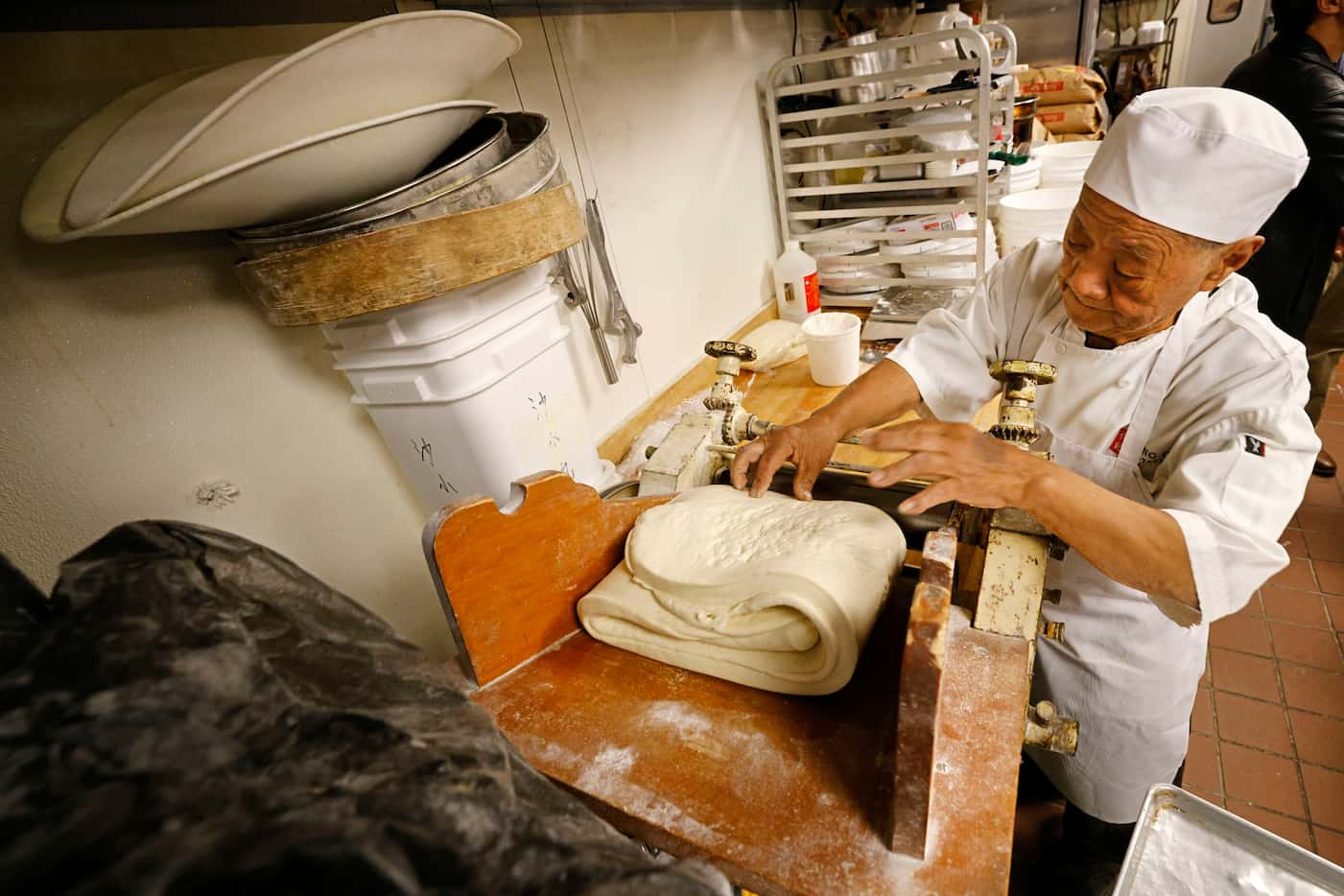 Yuan Hai Teng, founder of Jeng Chi restaurant, prepares dough to make buns at his...
