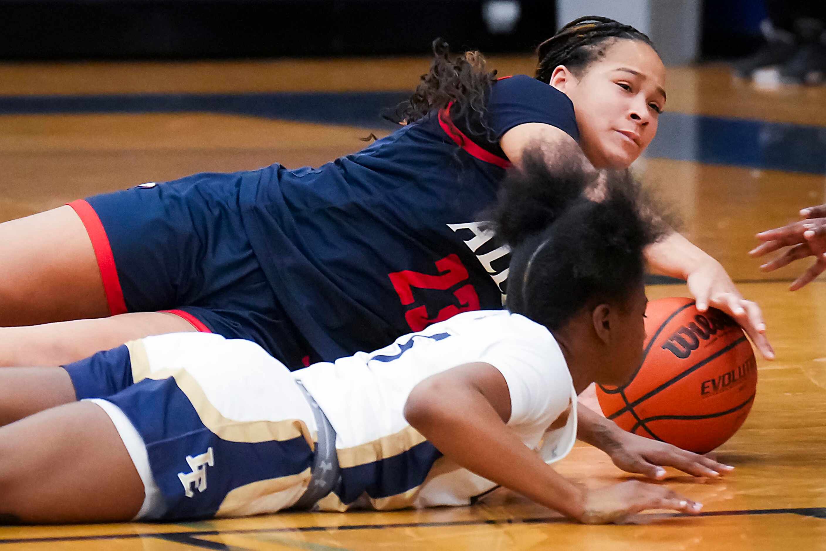Allen’s Aryn Roberts (23) fights for a loose ball against Little Elm's Madison Martin (5)...