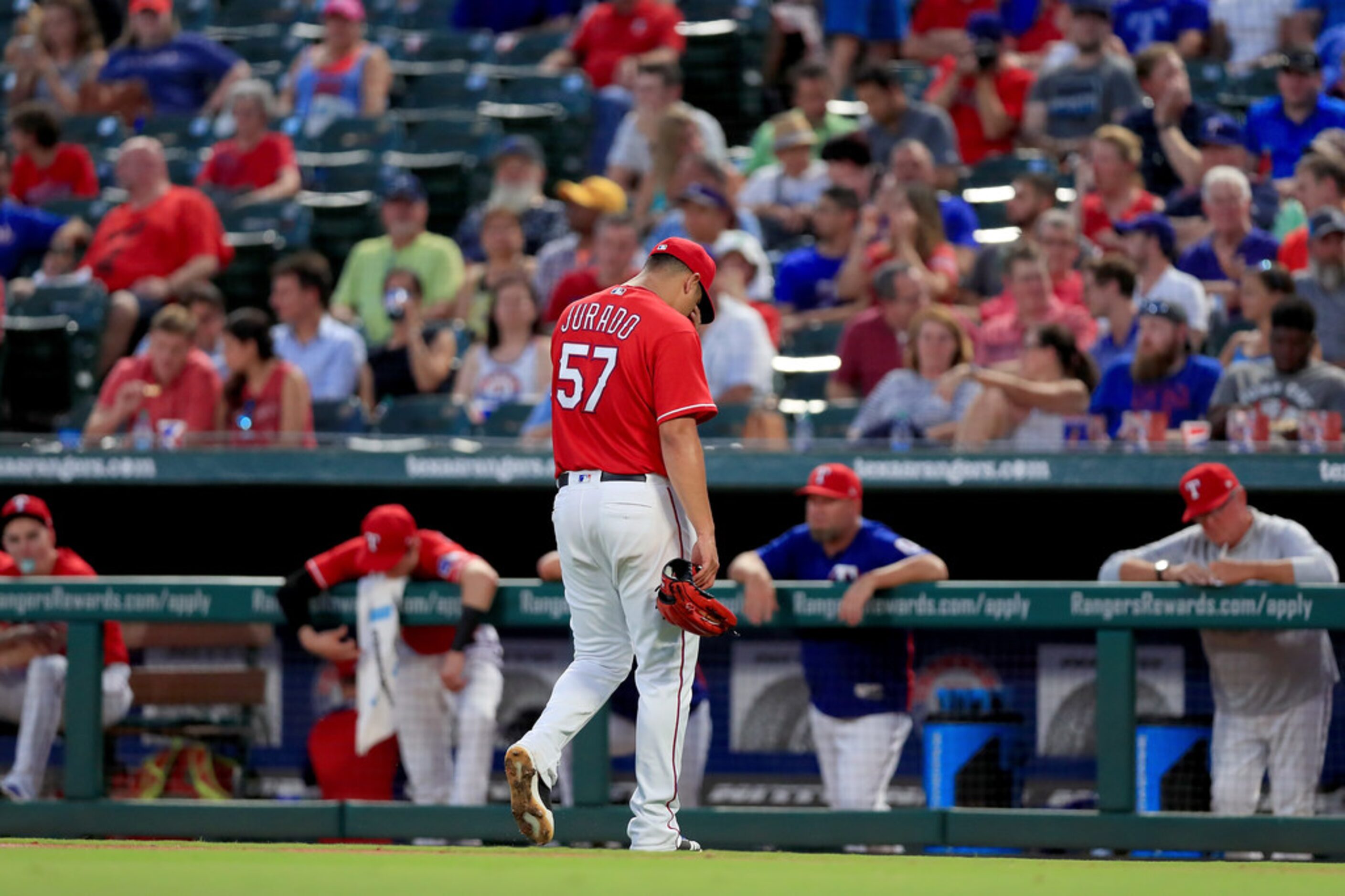 ARLINGTON, TX - AUGUST 28:  Ariel Jurado #57 of the Texas Rangers walks to the dugout after...