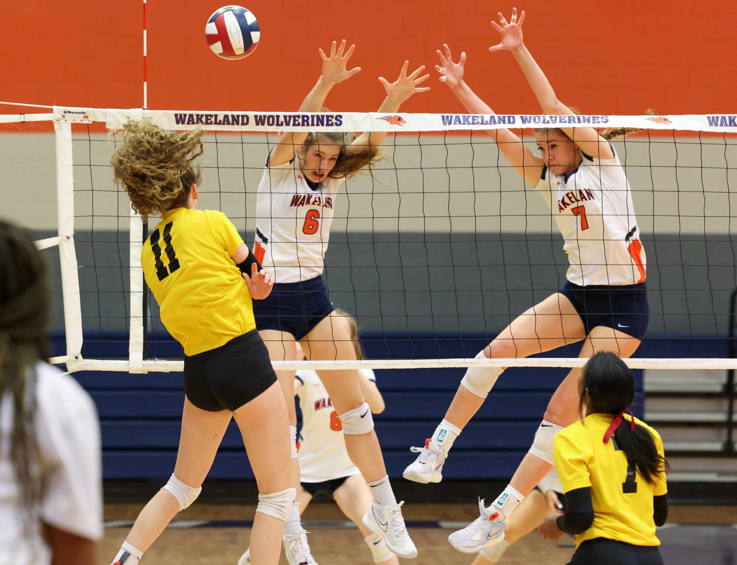 Frisco ISD’s Memorial High School Ava Steffe (11) spikes the ball over the net to defending...
