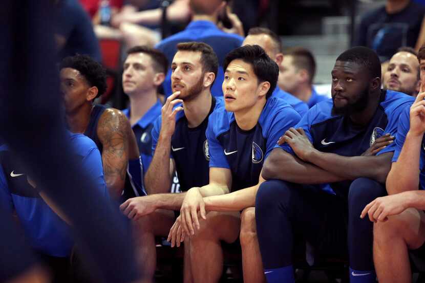 Dallas Mavericks' Yudai Baba, center, watches play from the bench during an NBA summer...