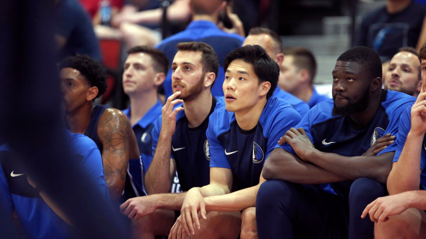 Dallas Mavericks' Yudai Baba, center, watches play from the bench during an NBA summer...