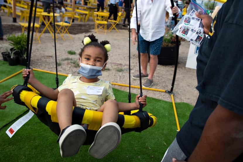 Carter Livingston, 4, soared in a swing at the launch of the MLK Food Park in Dallas on...