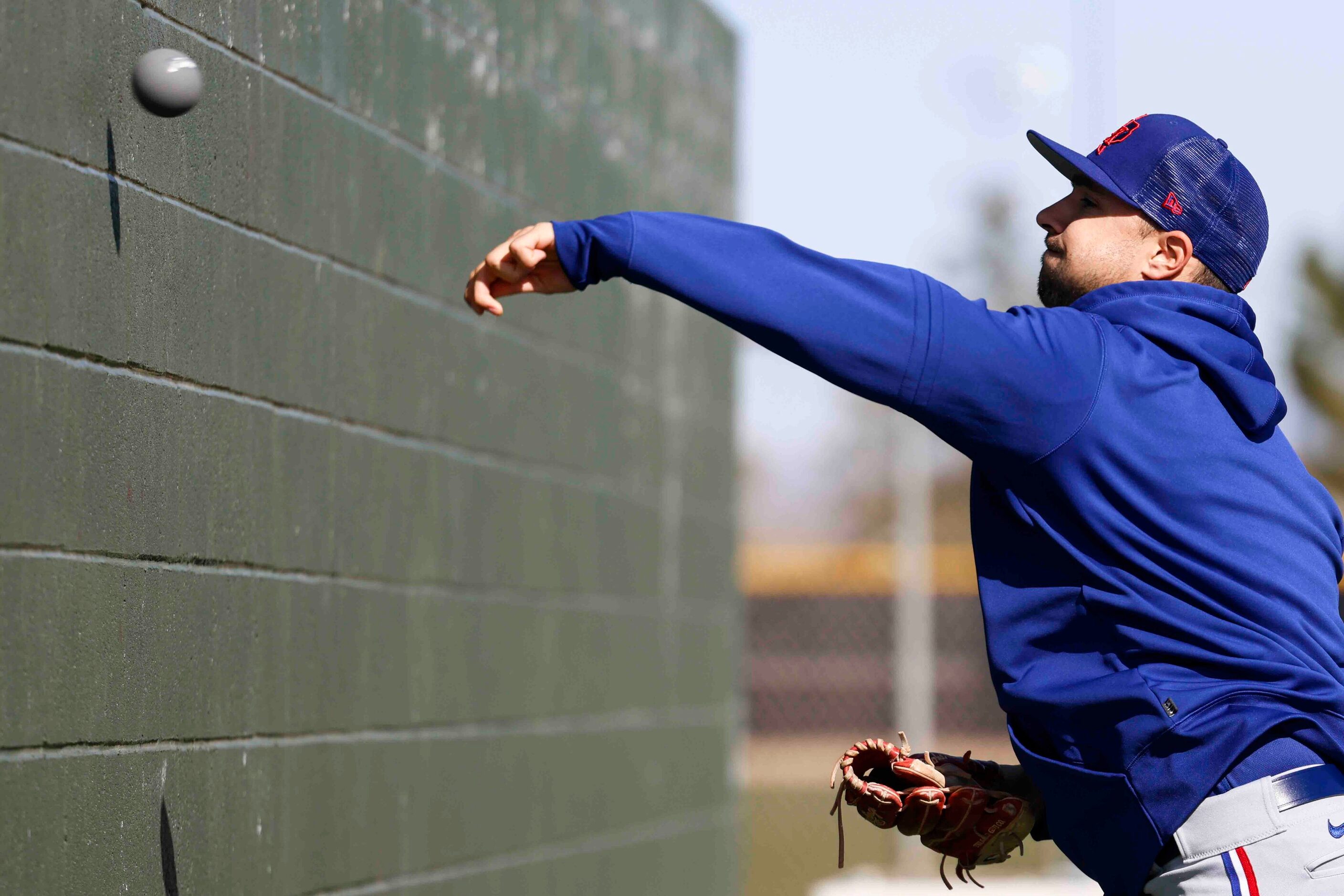 Texas Rangers left handed pitcher Brock Burke practices pitching against a wall during a...