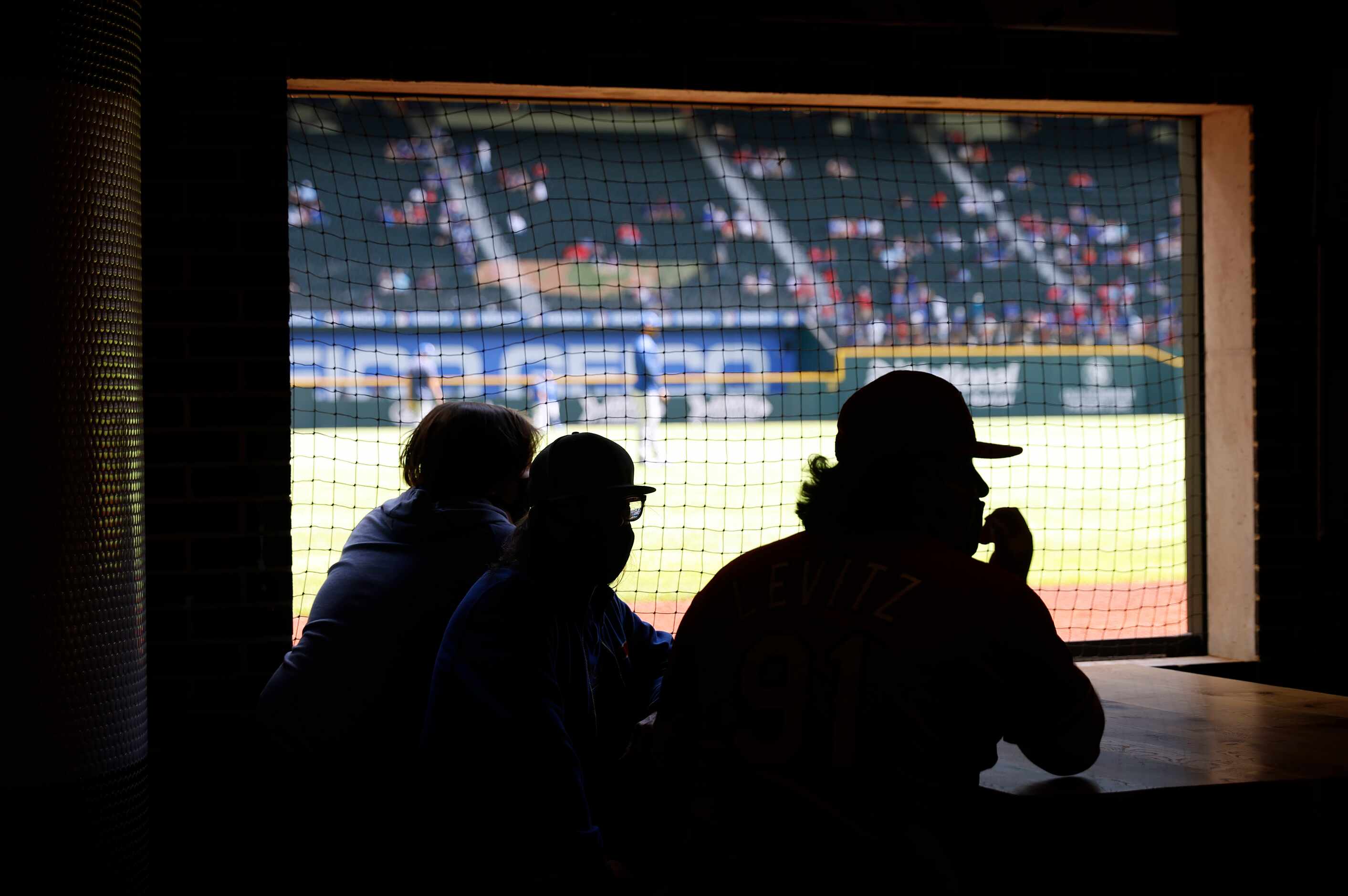 Texas Rangers fans watch batting practice from a field level club during during Opening Day...