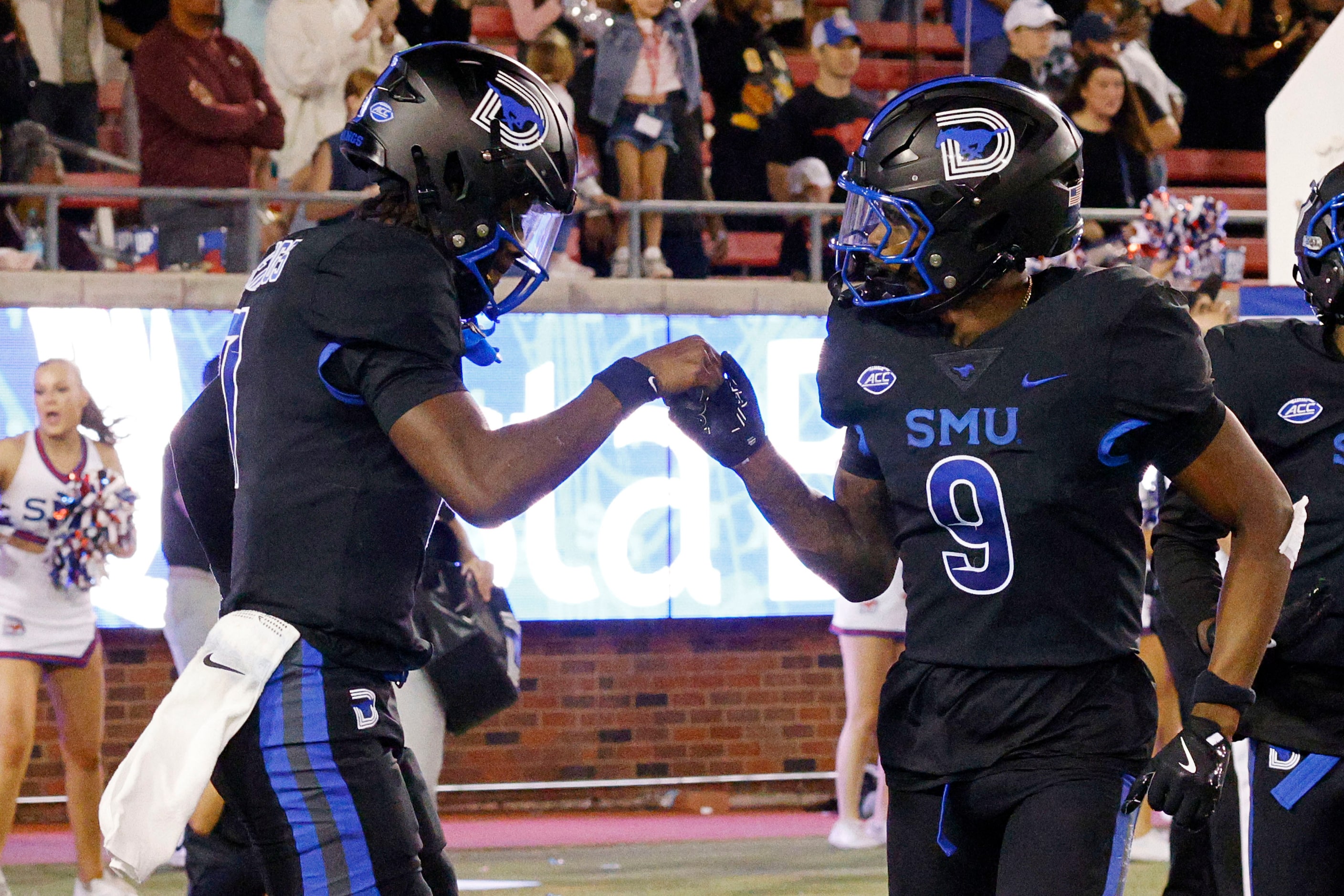 SMU quarterback Kevin Jennings (7), left, celebrates his touchdown pass to SMU wide receiver...