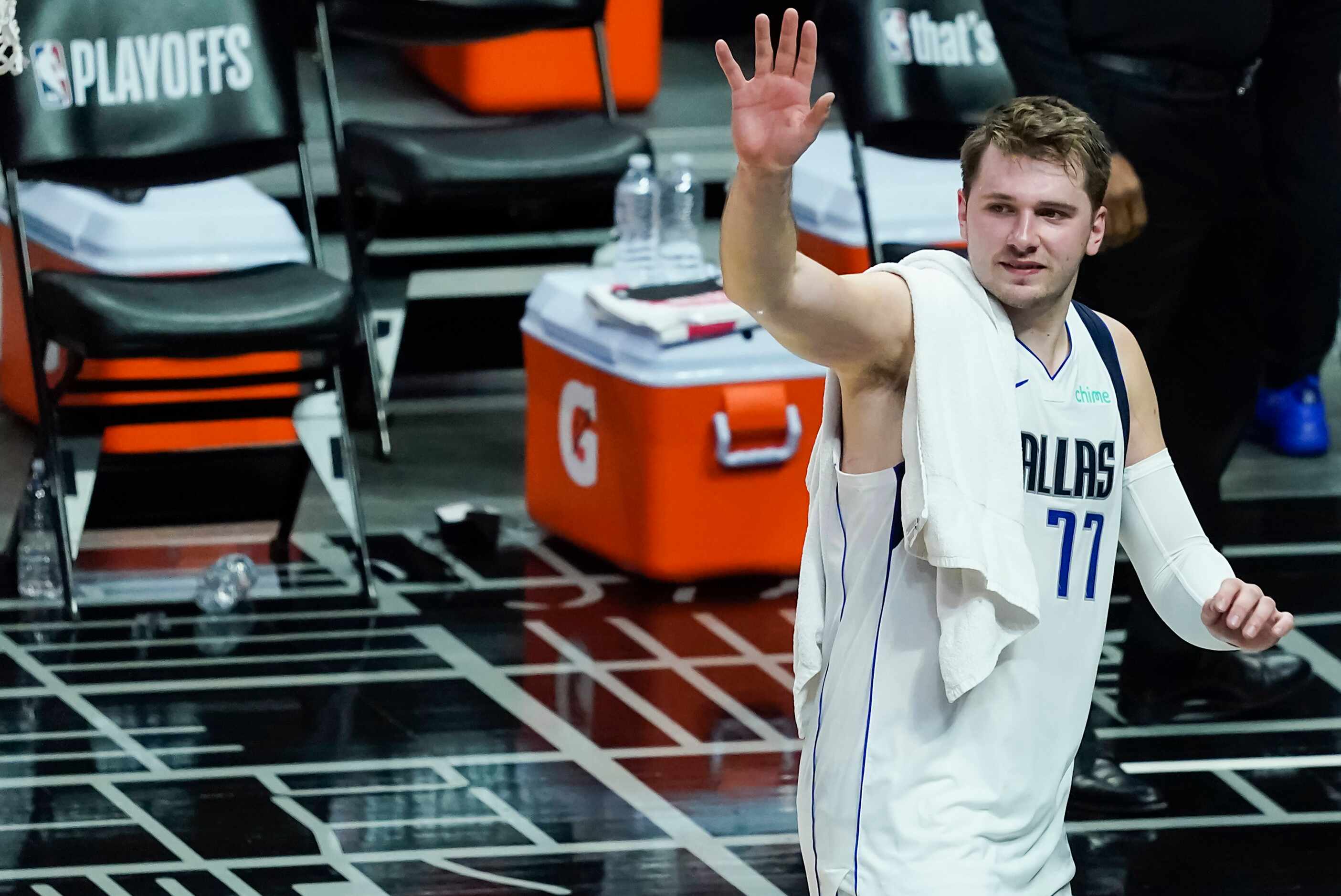Dallas Mavericks guard Luka Doncic waves to fans as he leaves the court after a win over the...