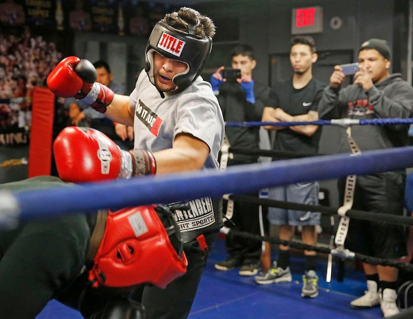 Rafael Gaitan Jr.  (top) of Grand Prairie spars with Greg Dismukes of Arlington at Reyes...