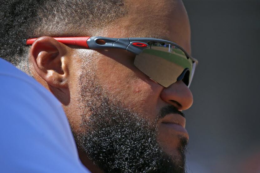 Texas Rangers' Prince Fielder watches the game at the end of the 8th inning against Seattle...