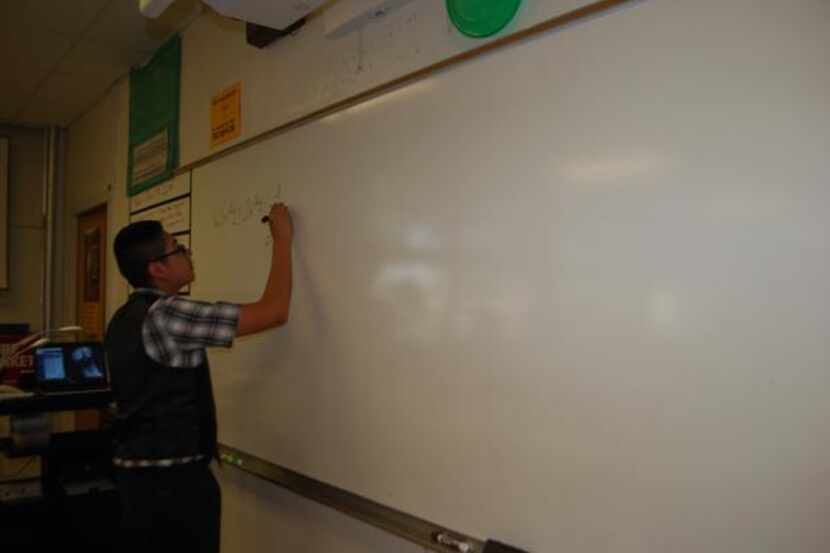 Bryan Adams Junior Eric Lopez, 17, works a simple equation on the board in Grant Ashmore’s...