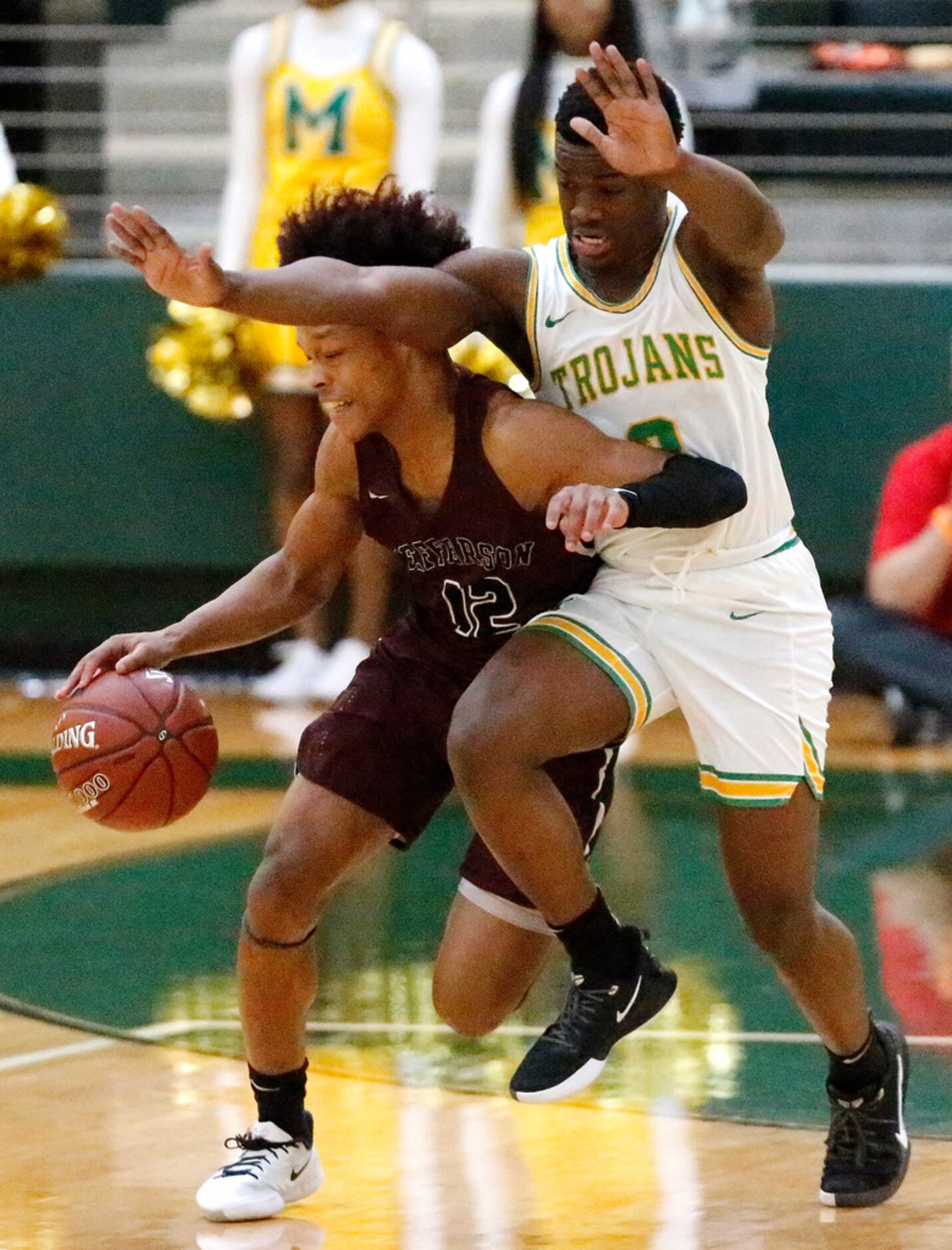 Jefferson High School guard Christian Shepard (12) draws contact with Madison High School...