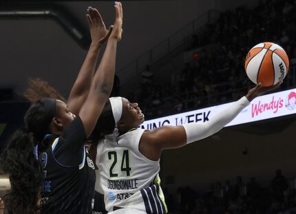 Dallas Wings guard Arike Ogunbowale (24) shoots as Chicago Sky guard Michaela Onyenwere (12)...