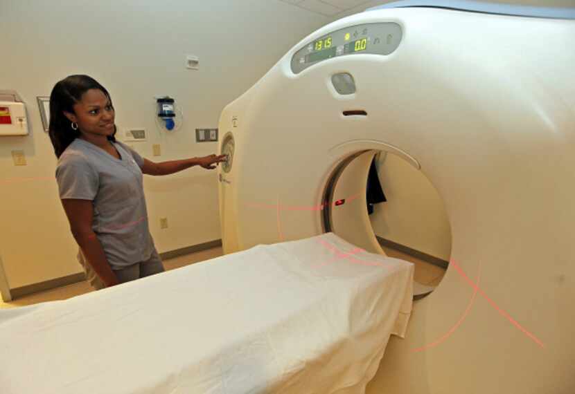 Mahogany Bircher of Little Elm prepares a CT scanner at  Emerus Emergency Hospital in Aubrey.