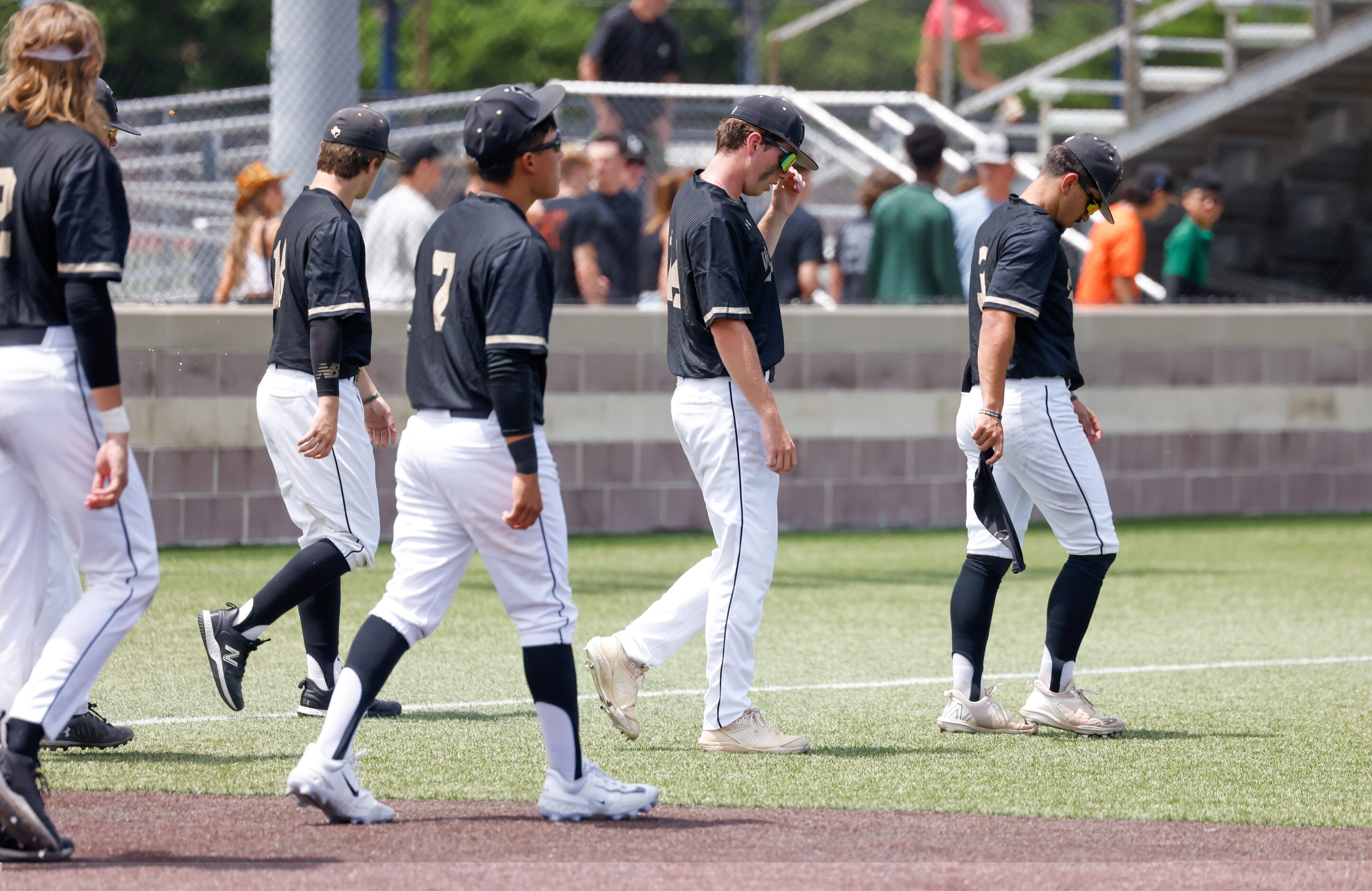 Mansfield players move to the outfield for a post-game talk after being defeated by Rockwall...