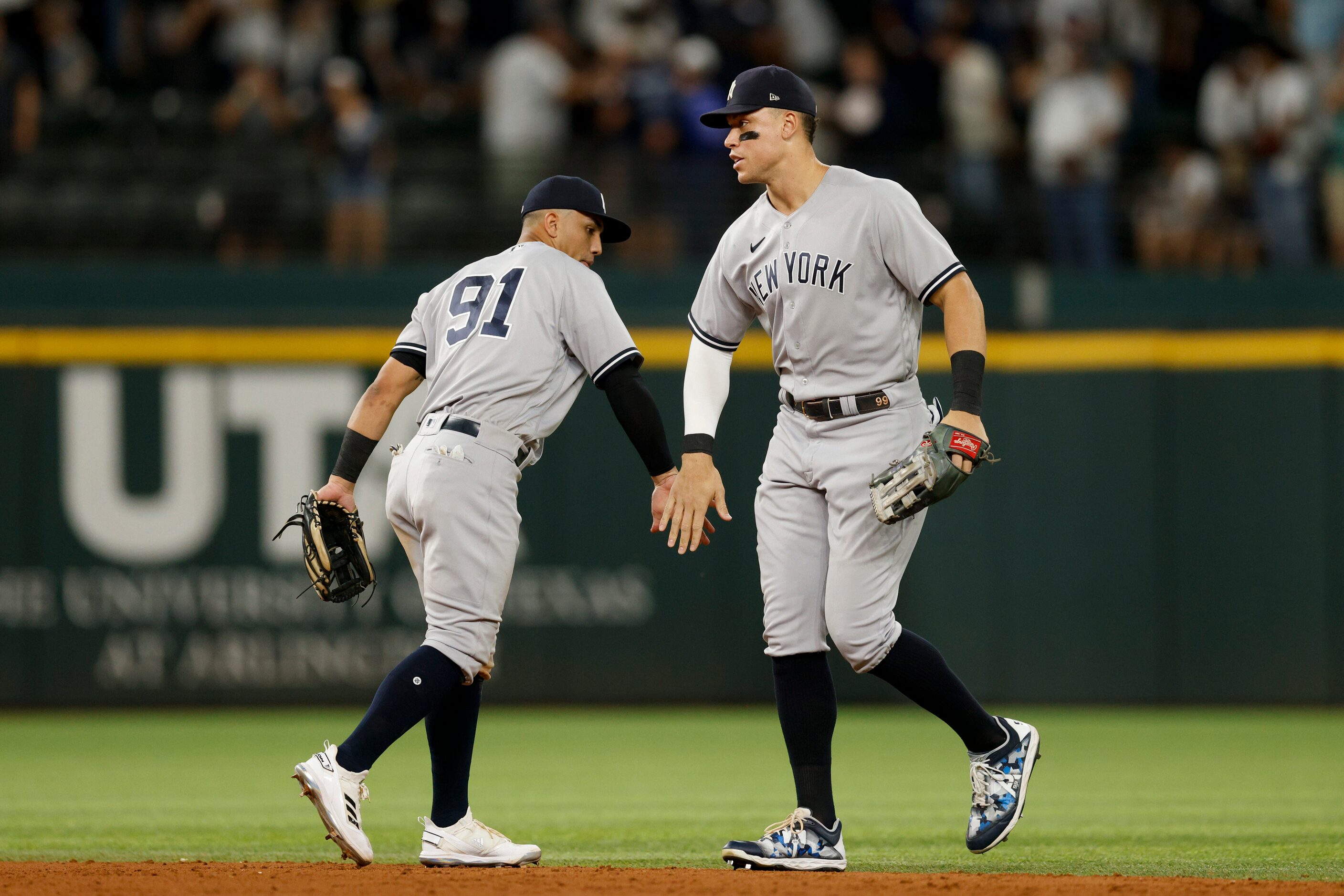 New York Yankees second baseman Oswald Peraza (91) high-fives right fielder Aaron Judge (99)...