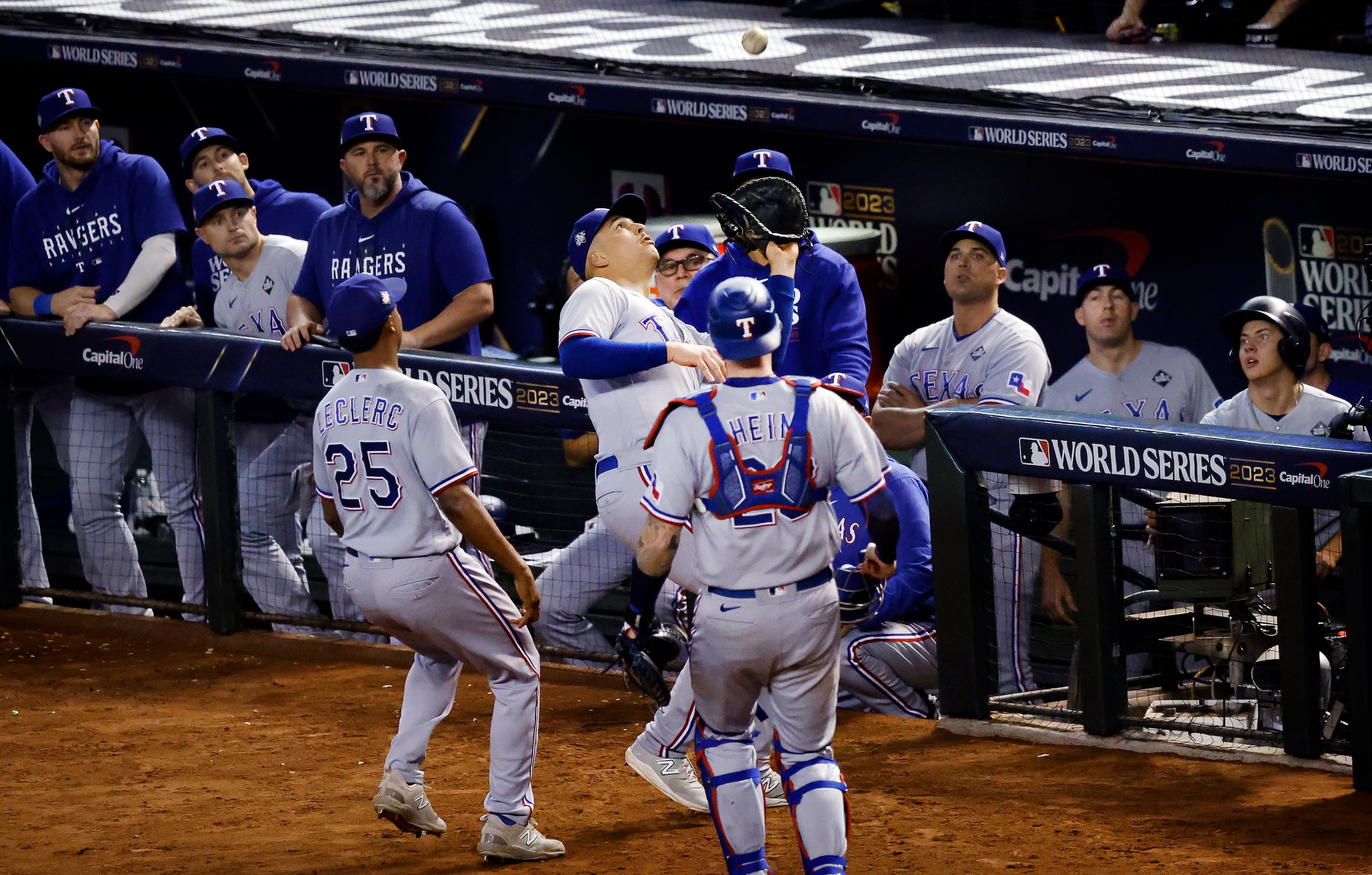 Texas Rangers first baseman Nathaniel Lowe (30) races to the dugout to catch the final out...