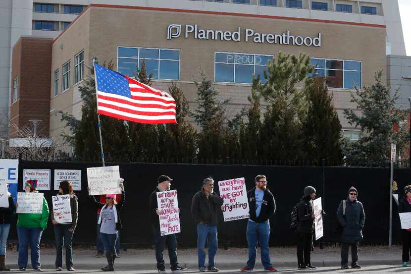 FILE - In this Feb. 11, 2017 file photo, pro-choice counter-protesters hold signs supporting...