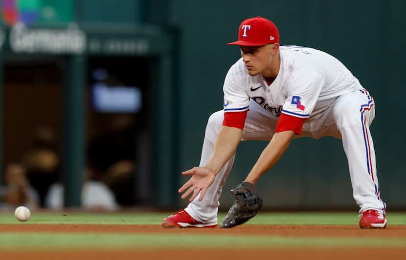 Texas Rangers shortstop Corey Seager (5) fields a ball to turn a double play during the...