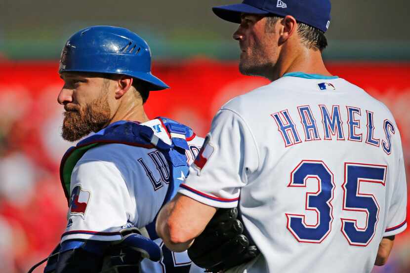 Texas Rangers catcher Jonathan Lucroy (25) and pitcher Cole Hamels (35) are pictured during...
