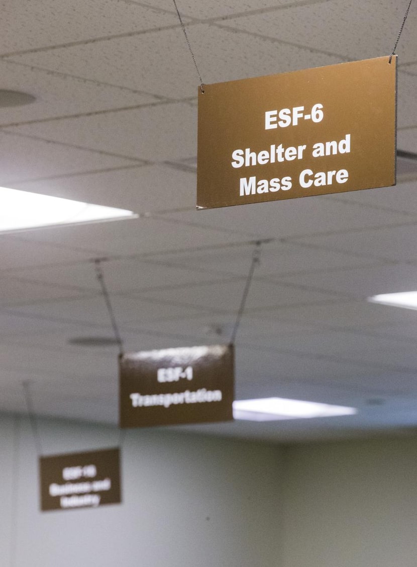 Signs indicating  where experts sit hang in a control room facility that allows them to...