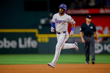 Texas Rangers' Marcus Semien jogs the bases after hitting a home run off Detroit Tigers...