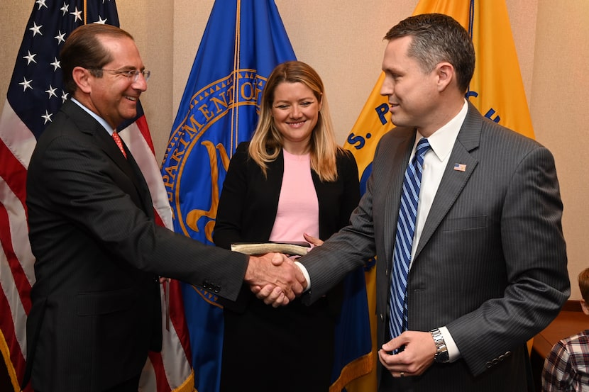 Alex Azar, left, U.S. Secretary of Health and Human Services, congratulates Brian Harrison...