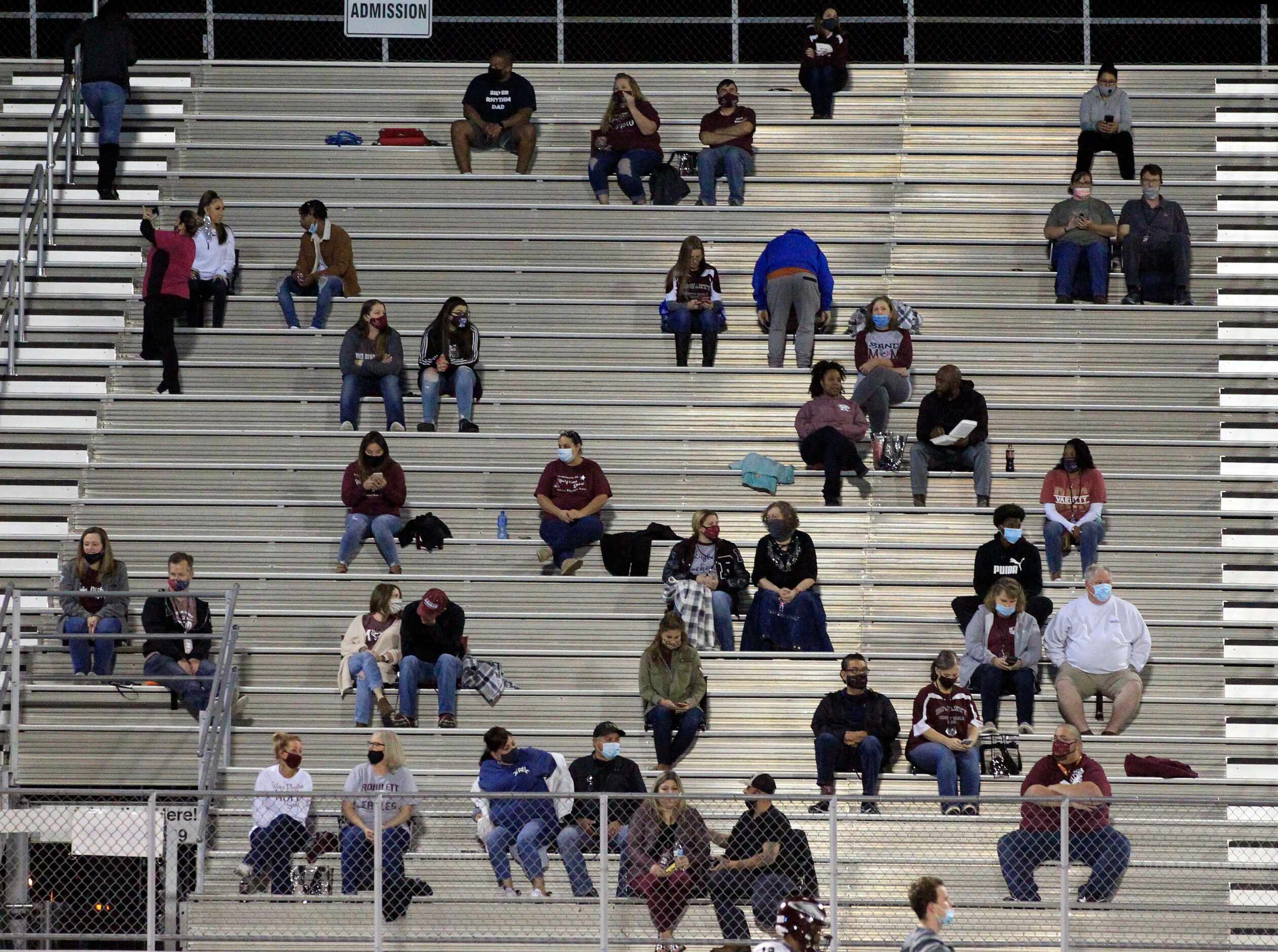 Rowlett fans carefully social distance from each other in the stands during the first half...
