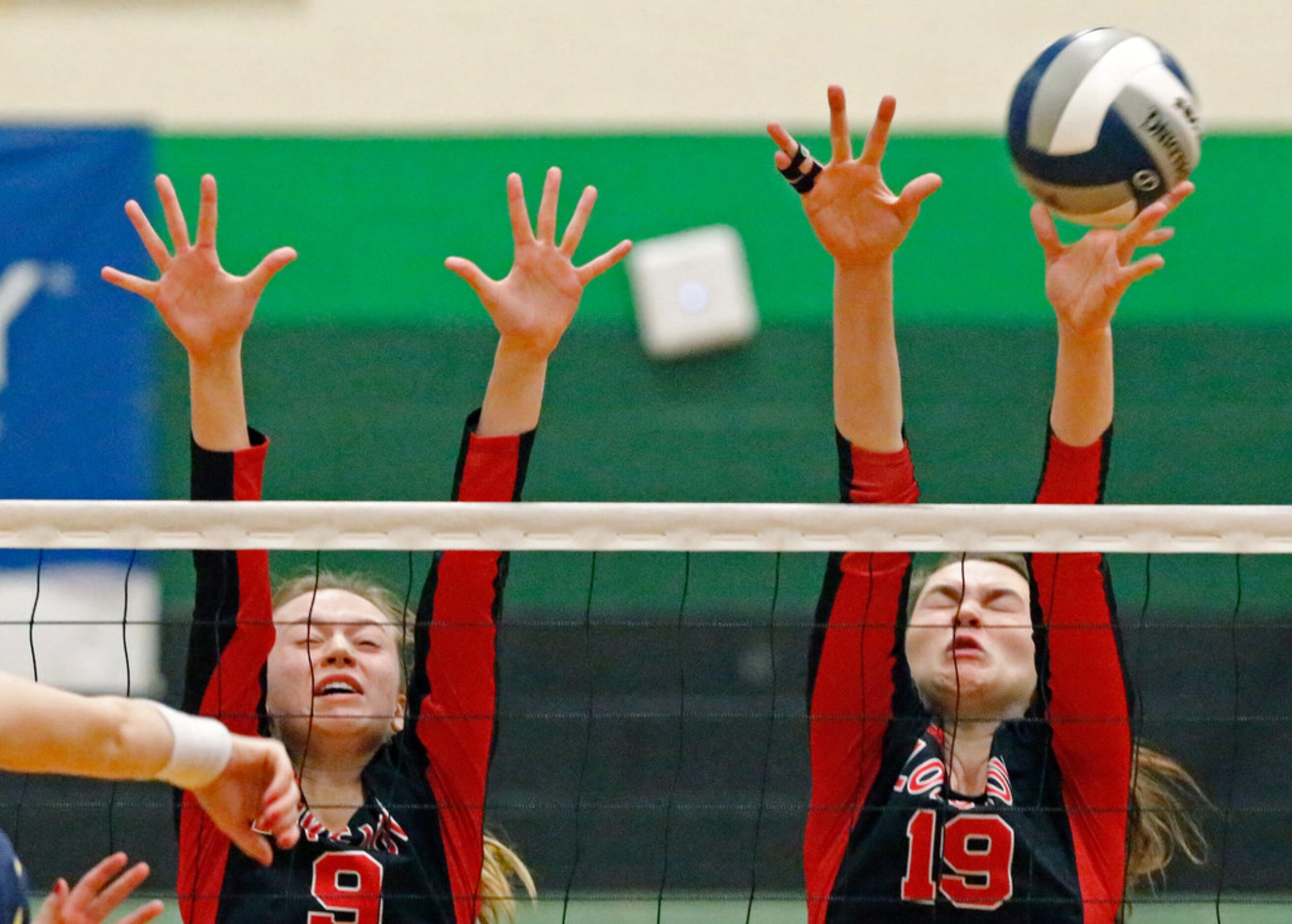 Lovejoy High School outside hitter Brynn Egger (8) and Lovejoy High School middle hitter...