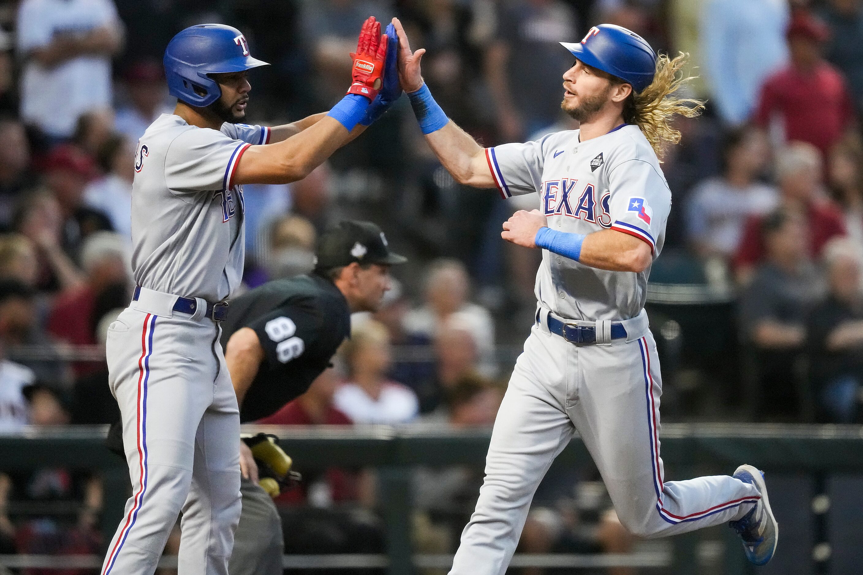 Texas Rangers right fielder Travis Jankowski celebrates with Leody Taveras (left) after...