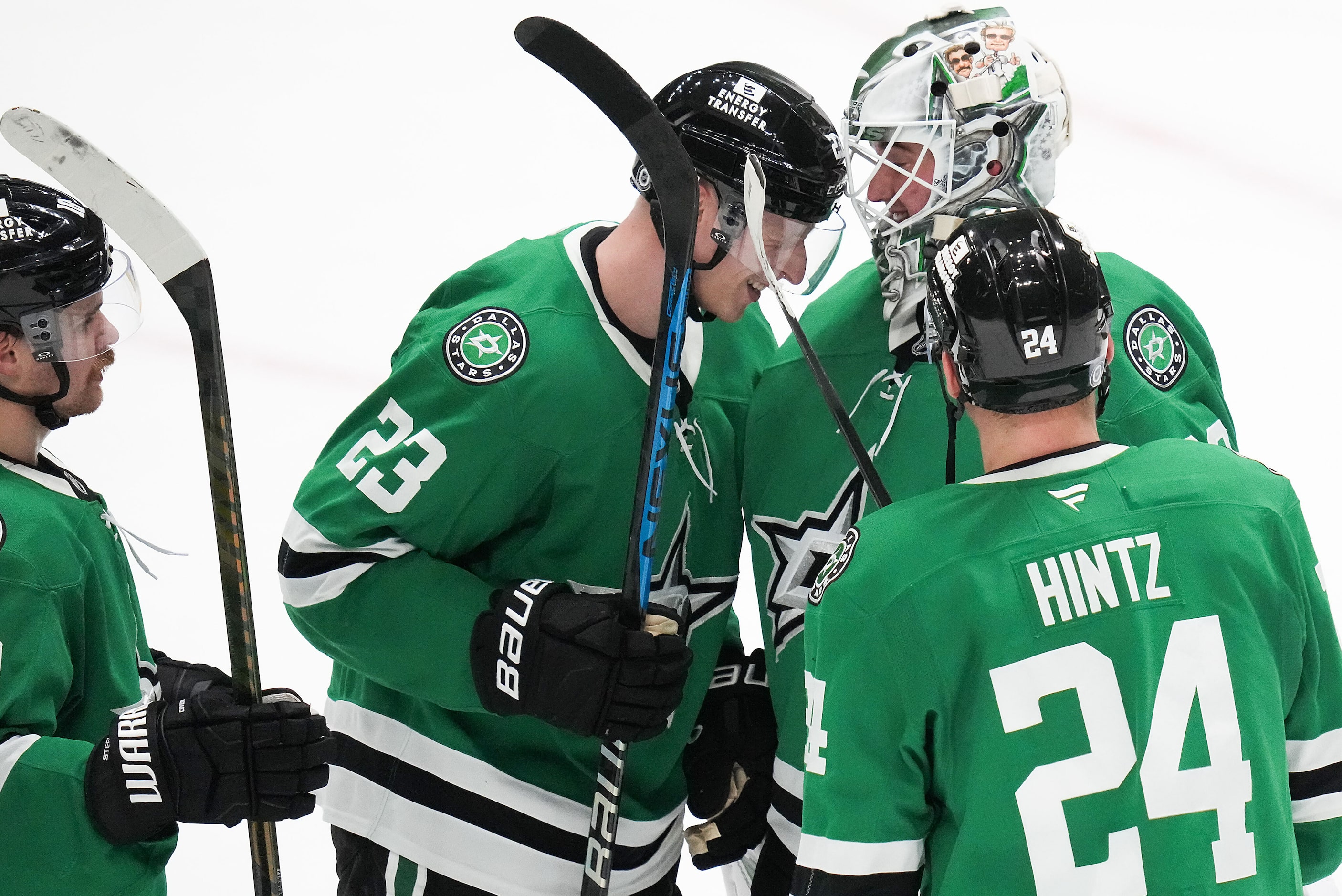 Dallas Stars goaltender Jake Oettinger (29) celebrates with defenseman Esa Lindell (23) and...