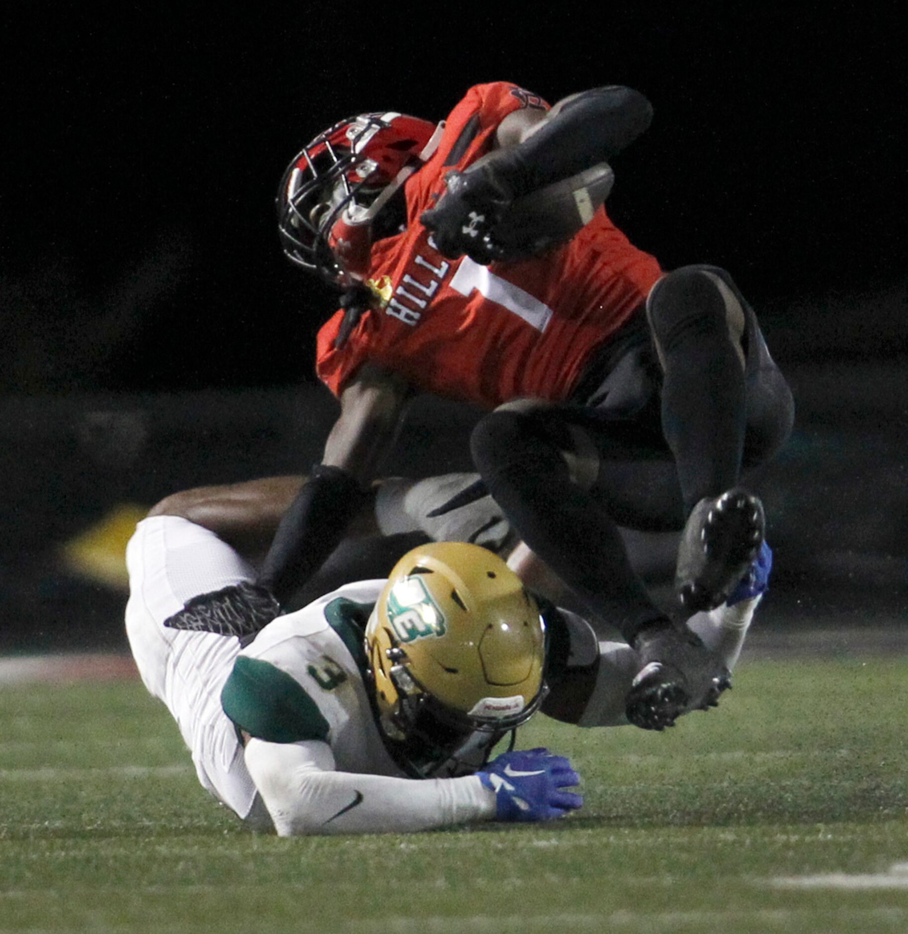 Cedar Hill receiver Cedric Mills (1) is upended by DeSoto linebacker Brandon Booker (3)...