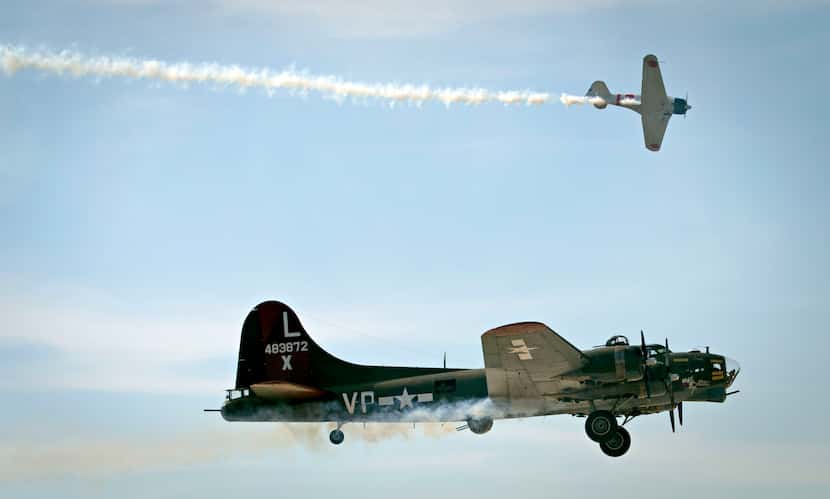 A B-17 and Japanese Zero airplane streak across the skies during a previous Wings Over...