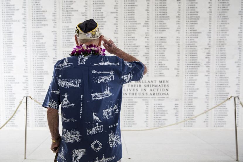USS Arizona survivor Lou Conter salutes the Arizona Remembrance Wall in Hawaii.