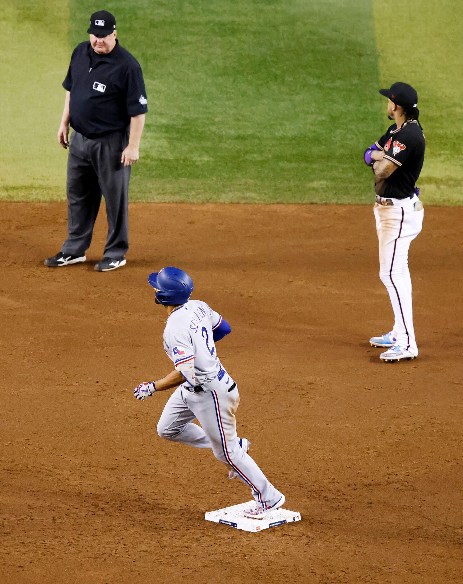 Texas Rangers’ Marcus Semien rounds the bases after hitting a three-run home run during the...