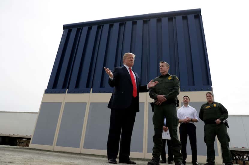 President Donald Trump reviews border wall prototypes, Tuesday, March 13, 2018, in San Diego. 