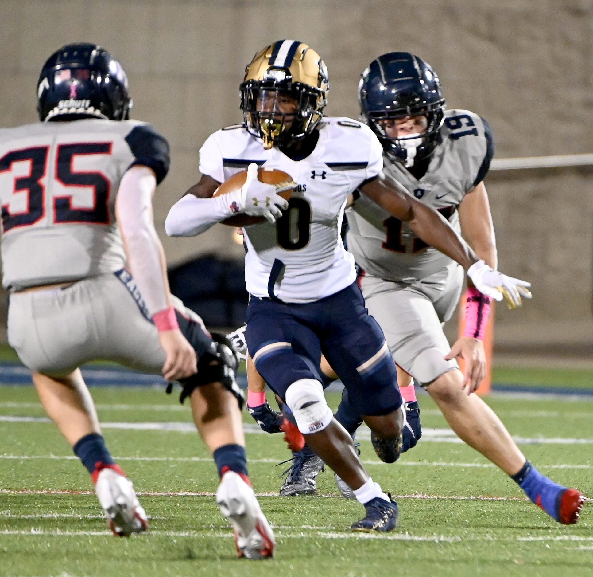 Little Elm’s Cameron Taylor-Butler runs between Allen’s Blake Harvey (35) and Diego Avila...