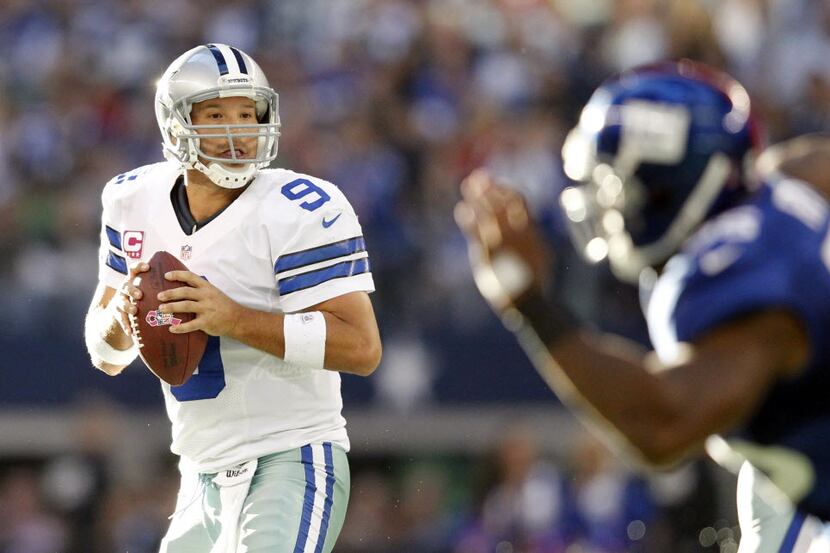 Dallas Cowboys quarterback Tony Romo (9) drops back to pass in a game against the New York...