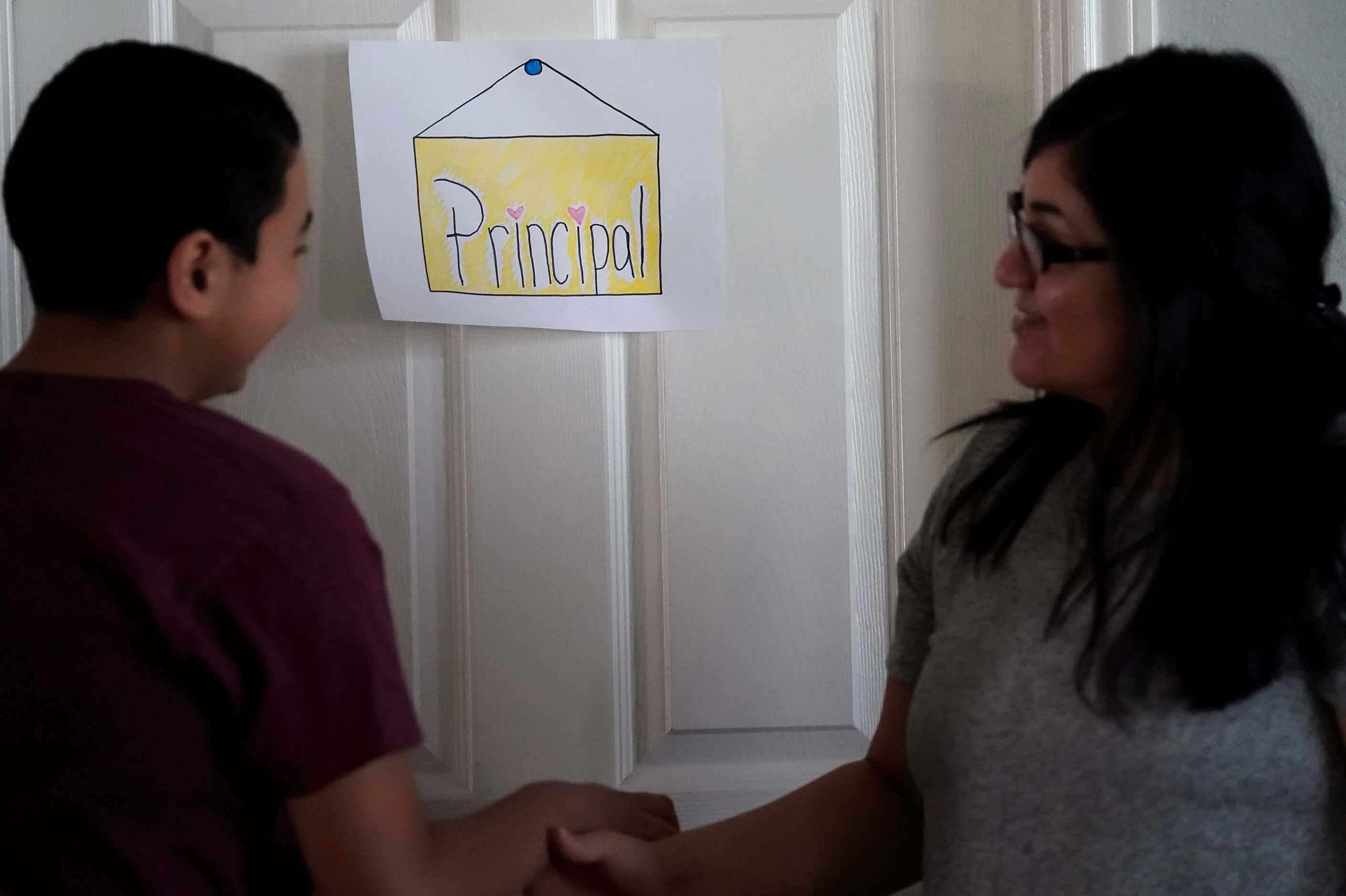 Francisco Cabrera, 13, jokes with his mother Nancy Segovia-Cabrera outside the "principal's...