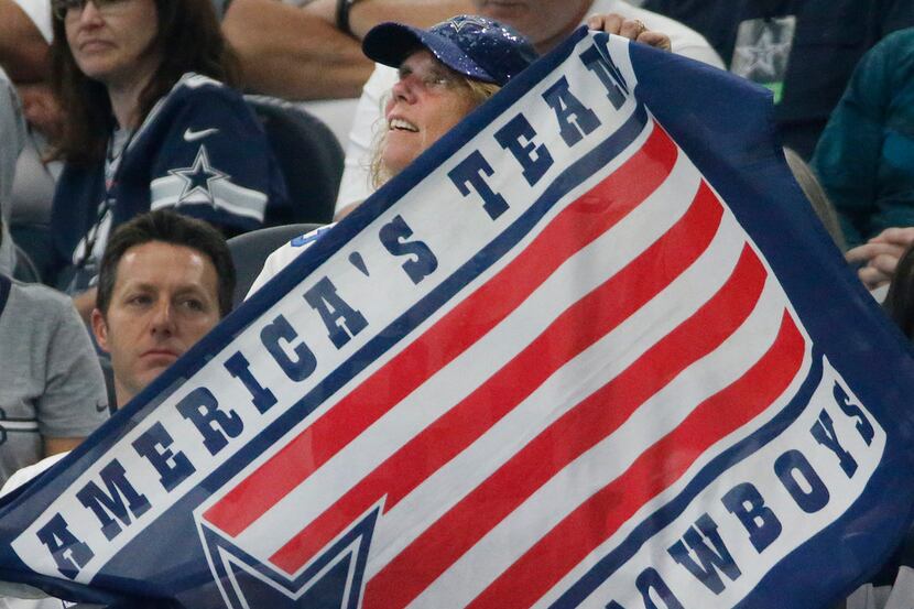 A Cowboys fan holds a Cowboys flag during the Green Bay Packers vs. the Dallas Cowboys NFL...