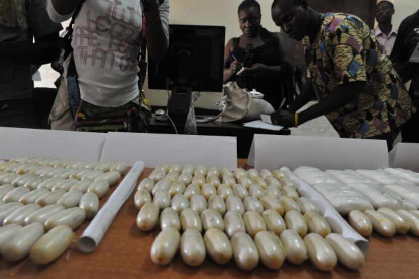 Seized packets of cocaine covered a table at a police station last month in Bissau, the...