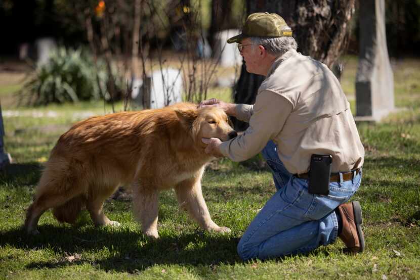 Oakland Cemetery board treasurer and volunteer Tom White with Rusty, who lives at the...