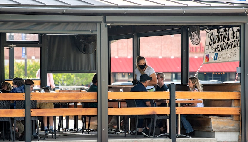 Patrons dine on the outdoor patio at Whiskey Cake Kitchen & Bar on Friday, May 1, 2020 in...