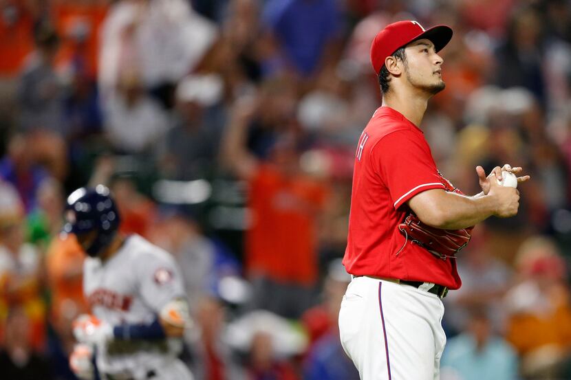 Texas Rangers starting pitcher Yu Darvish (11) looks towards the video board as Houston...