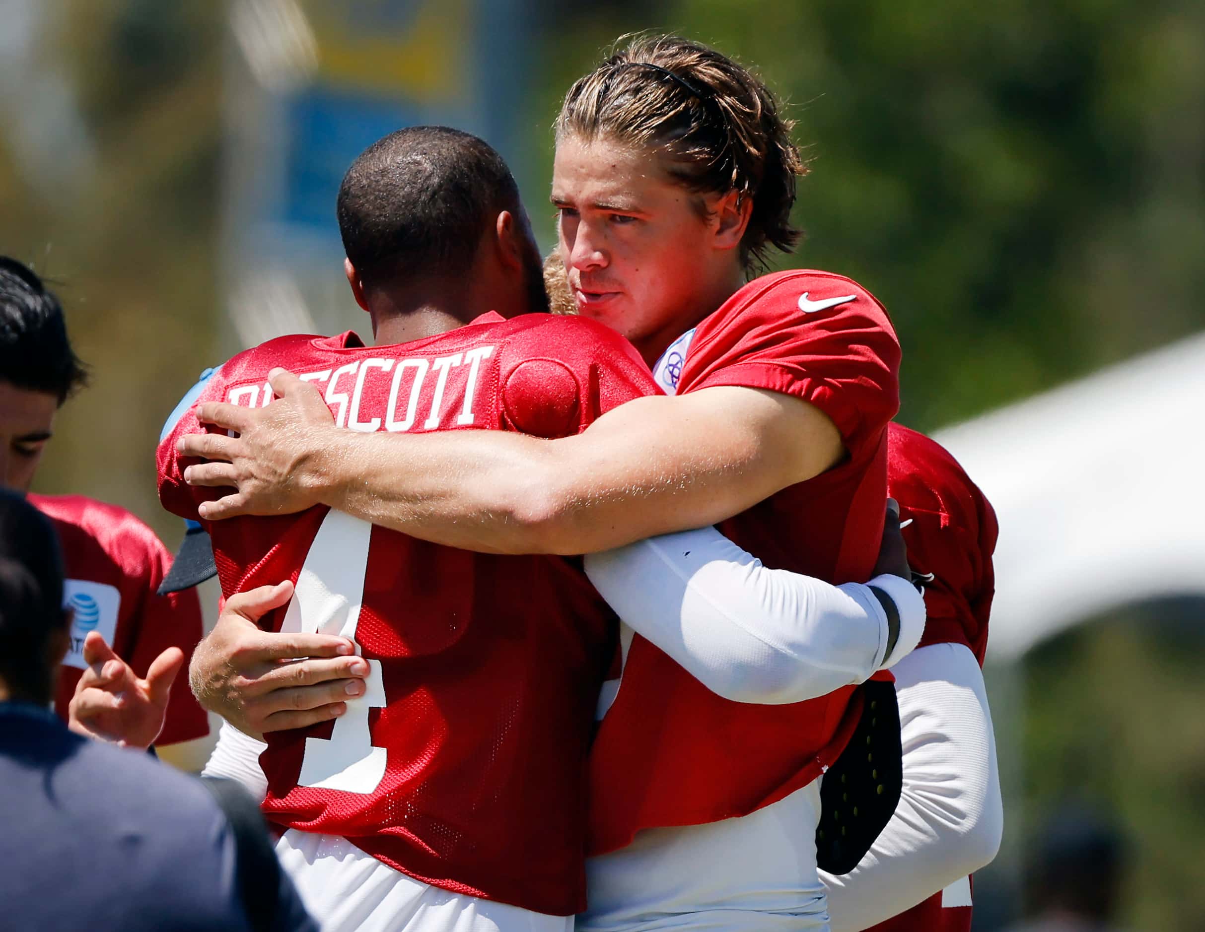 Dallas Cowboys quarterback Dak Prescott (left) received a hug from Los Angeles Chargers...