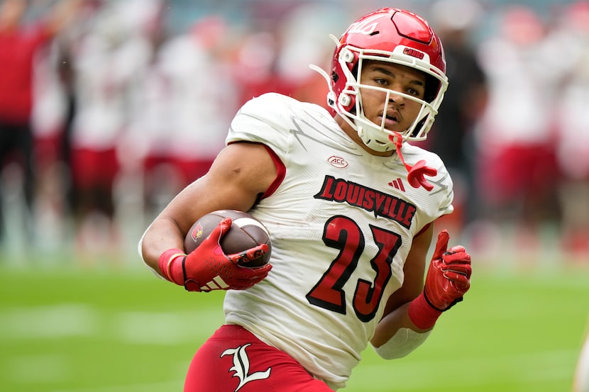 Louisville running back Isaac Guerendo runs in for a tough down during the first half of an...