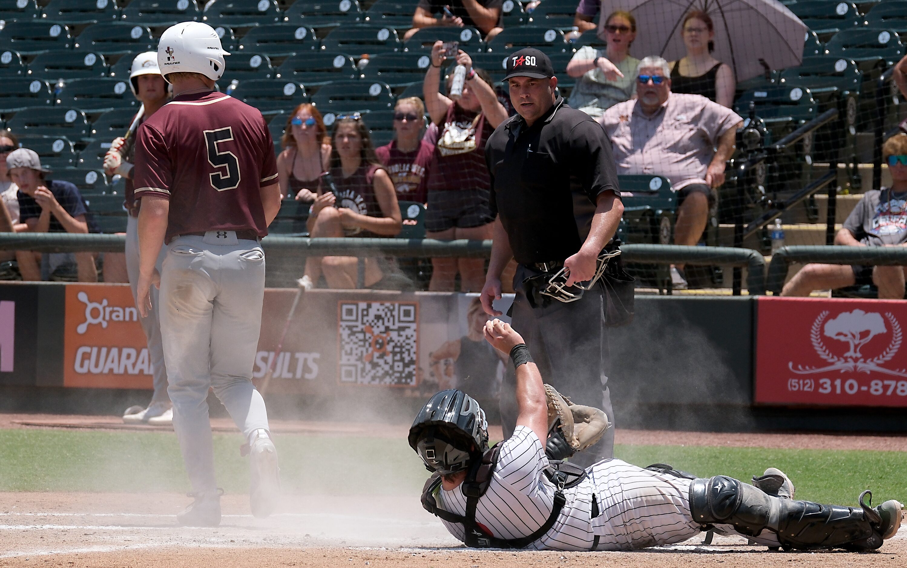 Argyle Hunter Sandifer, (8), shows umpire Ben Wood the ball after tagging out Magnolia West...