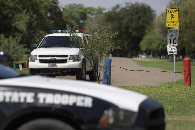  A U.S. Customs and Border Protection vehicle passes a Texas Department of Safety vehicle as...
