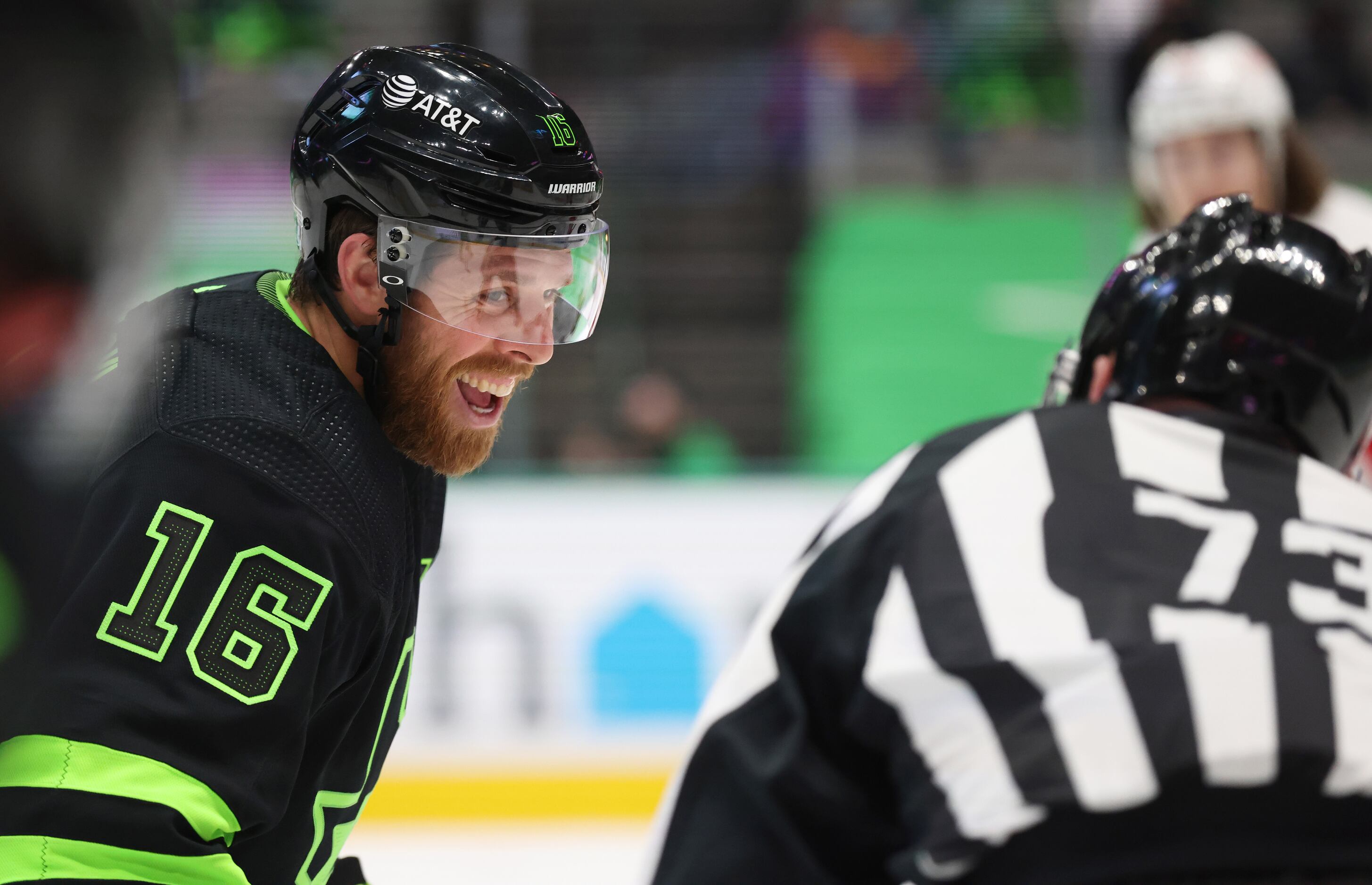 Dallas Stars center Joe Pavelski (16) laughs with linesman Vaughan Rody (73) before a...