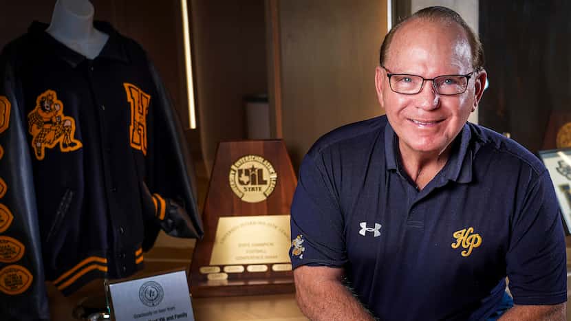 Highland Park football coach Randy Allen sits next to a display of the 2005 UIL state...